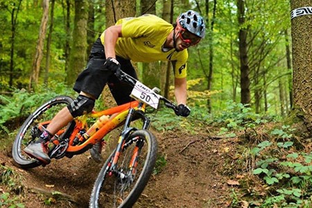 Tredz Charles Jones on an orange Giant Reign 27.5 1 MTB
